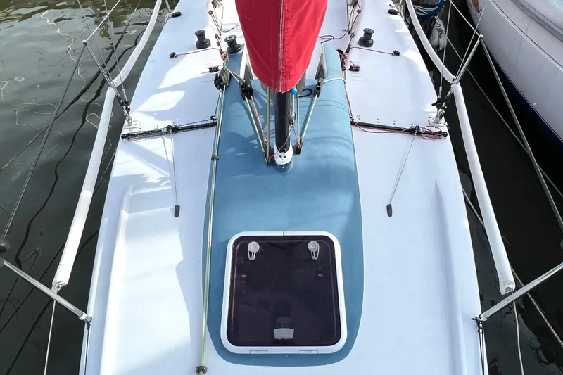 Slide: The Image of 2015 Wraceboats GP26 sailboat deck with red sail and blue hatch. - 17