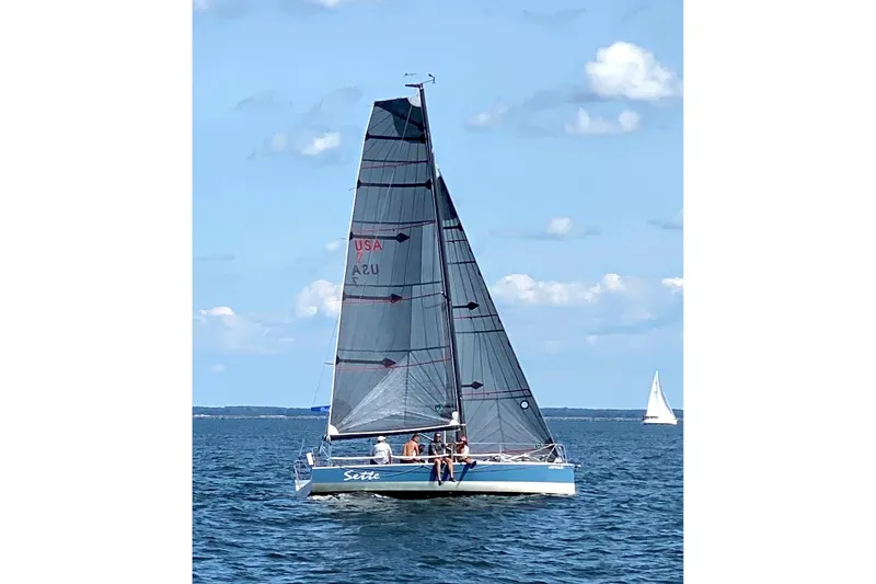 Slide: The Image of Sailboat Wraceboats GP26 2015 on open water under clear blue sky. - 2