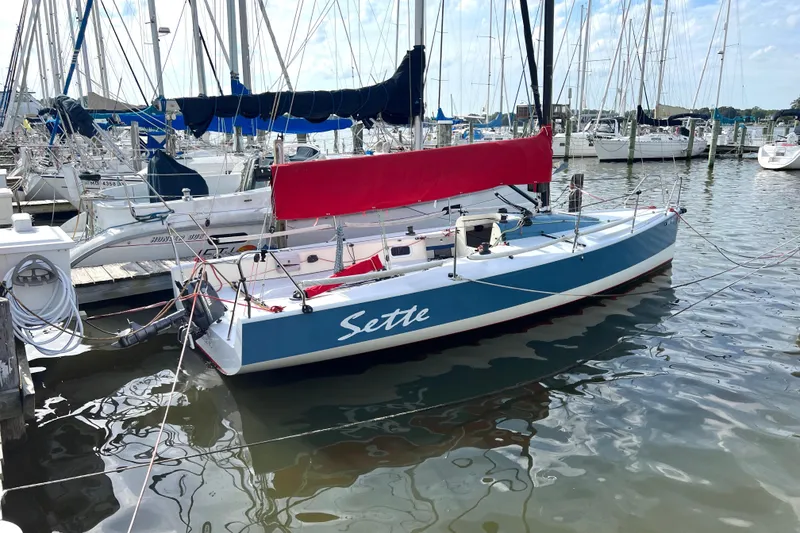 Slide: The Image of 2015 Wraceboats GP26 sailboat docked, featuring blue hull and red sail cover. - 5