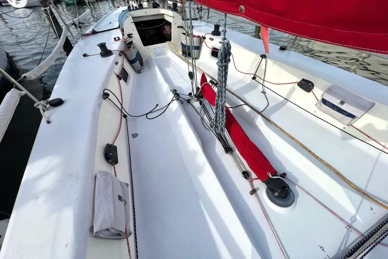 Slide: The Image of 2015 Wraceboats GP26 sailboat deck with red sail and rigging details. - 7