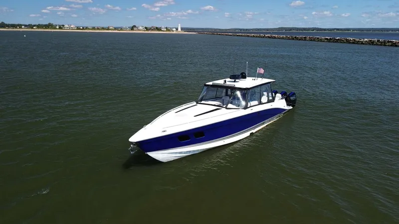 Slide: The Image of 2020 Concept 44' Cuddy Cabin boat on calm water, clear sky background. - 6