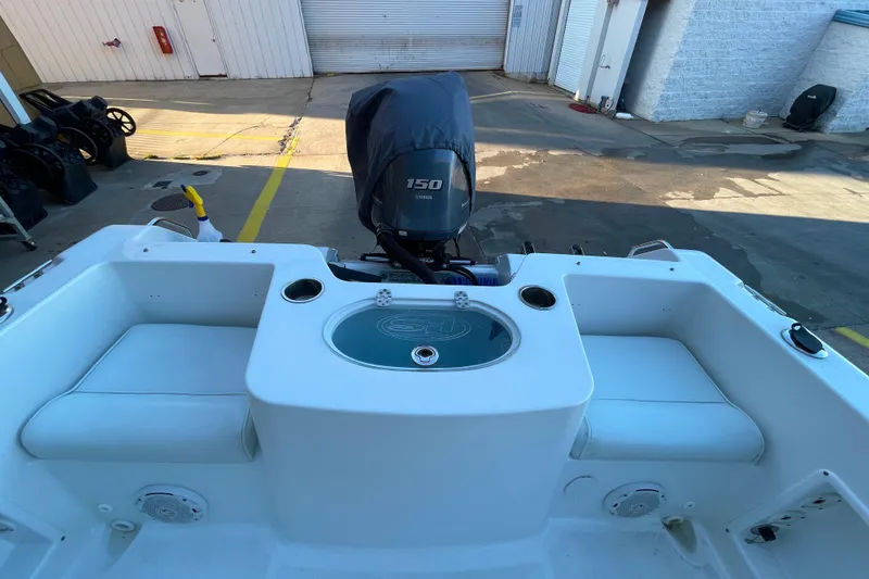 Slide: The Image of 2017 Sea Hunt Triton 210 boat interior with Yamaha 150 engine, featuring seating and storage. - 10