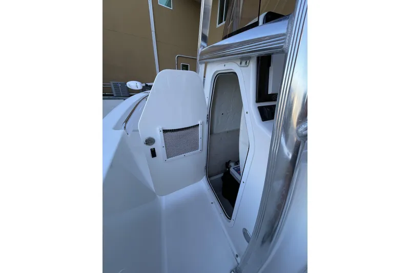 Slide: The Image of 2017 Sea Hunt Triton 210 boat interior with open storage compartment. - 23