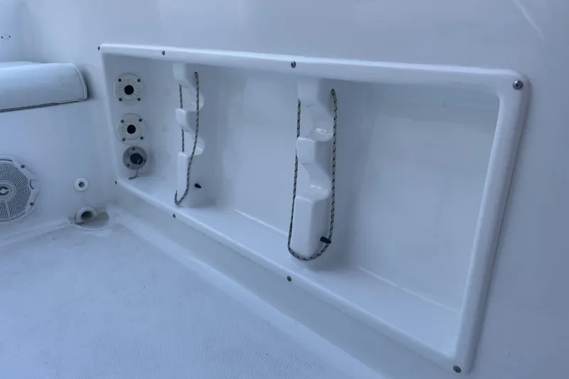 Slide: The Image of 2017 Sea Hunt Triton 210 boat interior with rod holders and speaker. - 24