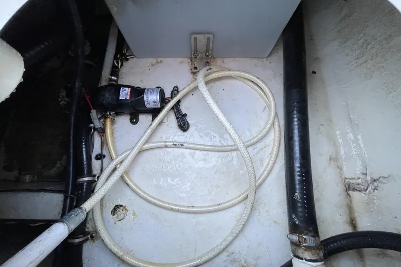 Slide: The Image of 2017 Sea Hunt Triton 210 boat interior with hoses and pump system. - 26