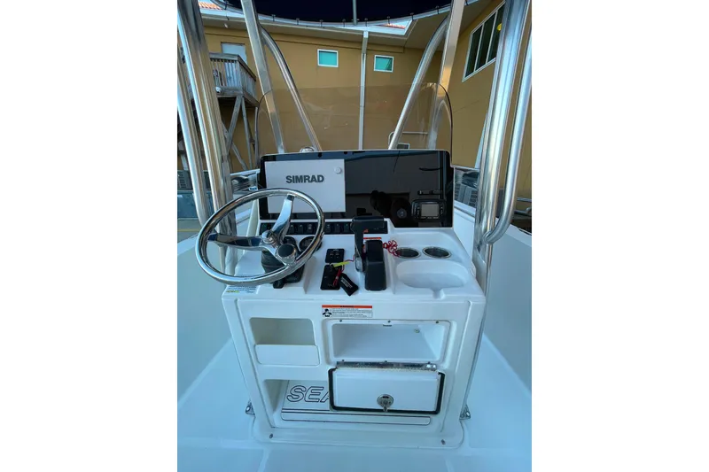 Slide: The Image of 2017 Sea Hunt Triton 210 boat console with steering wheel and Simrad electronics. - 4