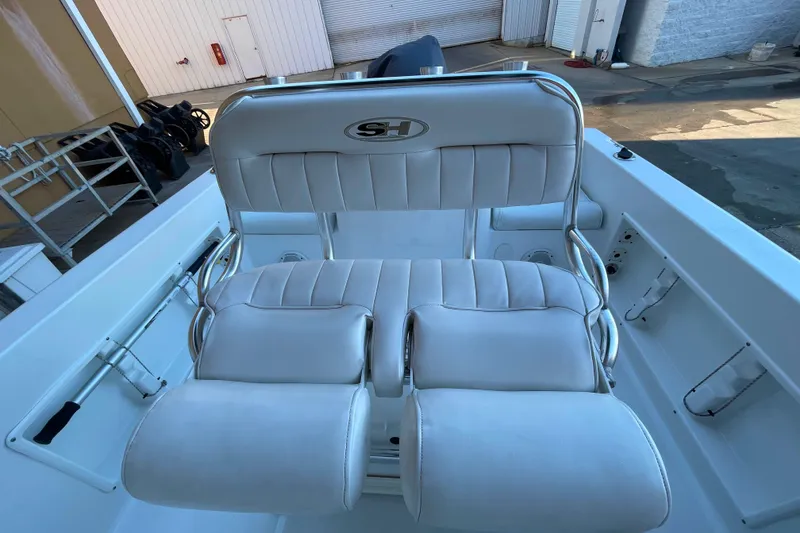 Slide: The Image of 2017 Sea Hunt Triton 210 boat with white cushioned seating and stainless steel frame. - 7