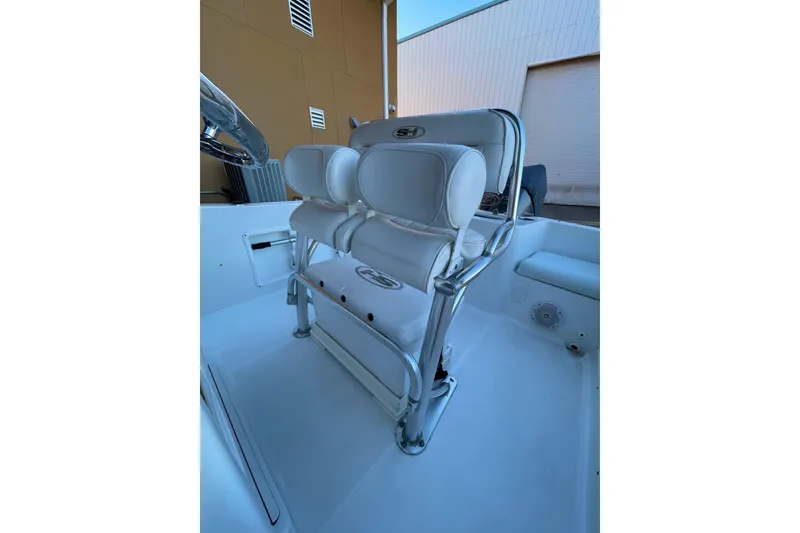 Slide: The Image of 2017 Sea Hunt Triton 210 boat interior with white cushioned seating. - 8