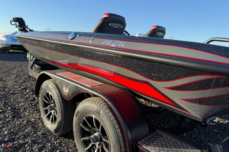 Slide: The Image of 2026 Phoenix 819 ZXL boat with sleek red and gray design on a trailer. - 10