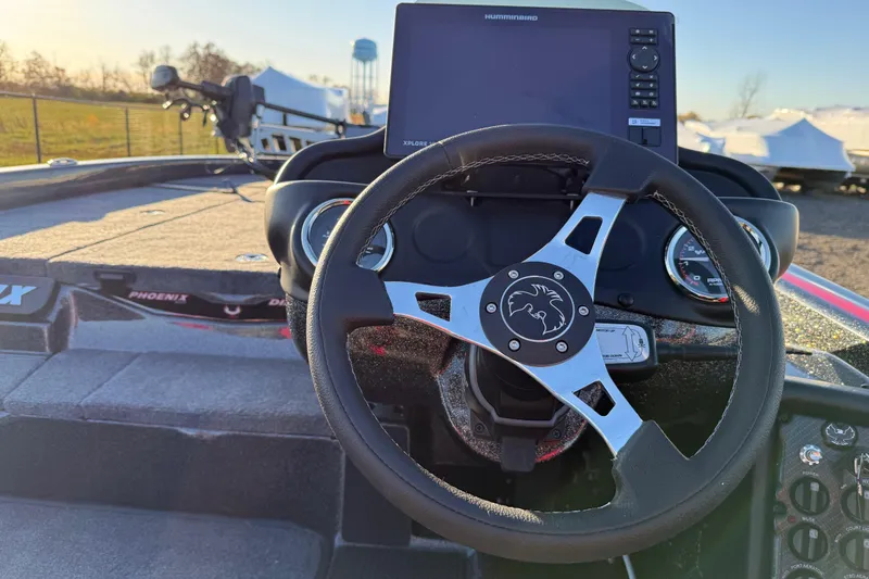Slide: The Image of Steering wheel and dashboard of 2026 Phoenix 819 ZXL boat with navigation display. - 12