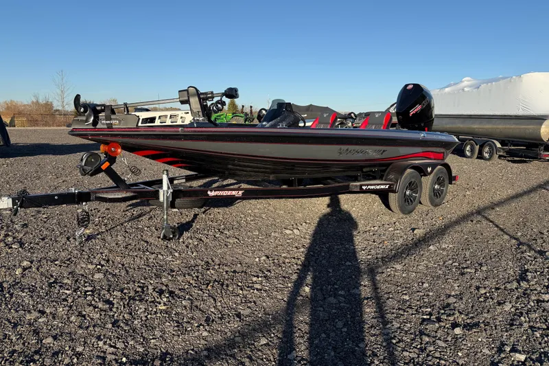 Slide: The Image of 2026 Phoenix 819 ZXL boat on trailer, parked on gravel under clear blue sky. - 6