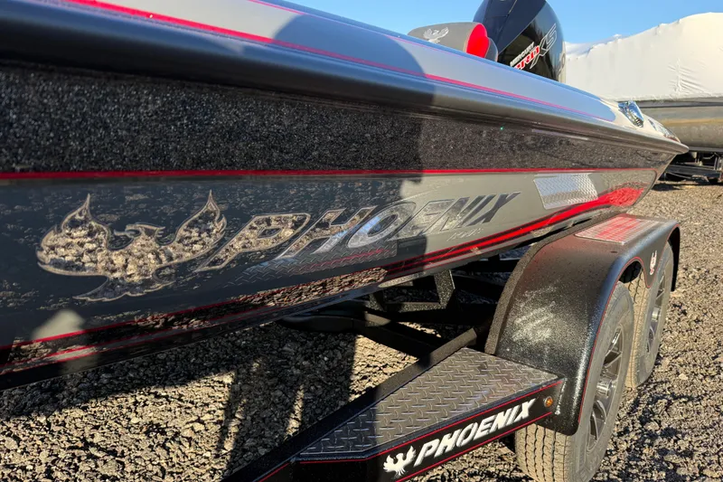 Slide: The Image of 2026 Phoenix 819 ZXL boat on trailer, showcasing sleek design and branding. - 8