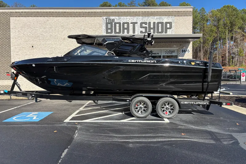 Slide: The Image of 2026 Centurion Ri245 boat on trailer at The Boat Shop parking lot. - 1