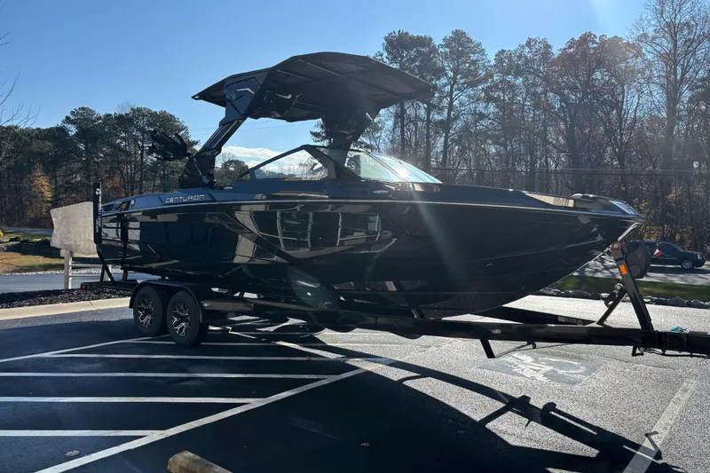 Slide: The Image of 2026 Centurion Ri245 boat on trailer in sunny parking lot. - 3