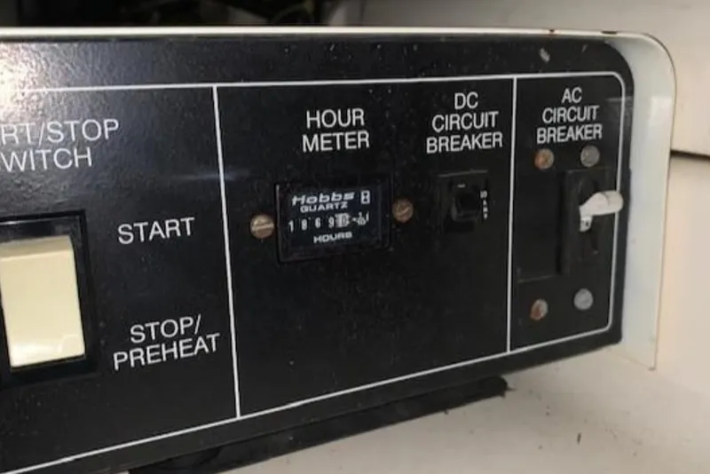 Slide: The Image of Control panel of a 1994 Carver 440 Aft Cabin Motor Yacht with hour meter and circuit breakers. - 14