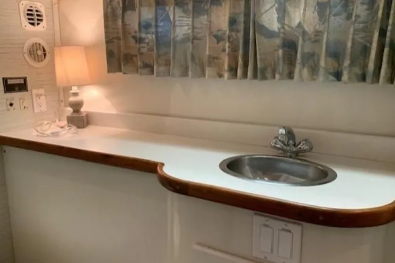 Slide: The Image of 1994 Carver 440 Aft Cabin Motor Yacht interior with sink and lamp. - 9