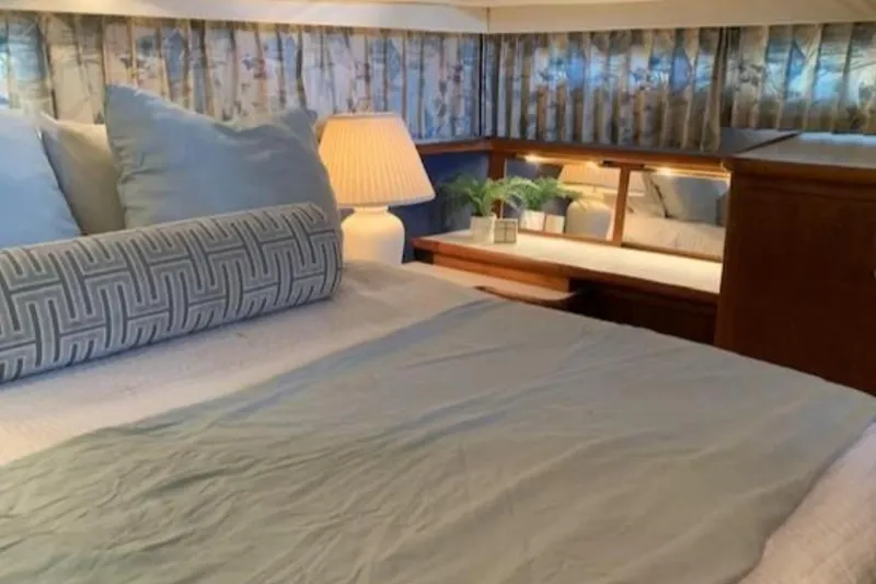 Slide: The Image of Cozy bedroom in 1994 Carver 440 Aft Cabin Motor Yacht with elegant decor. - 10