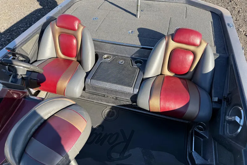 Slide: The Image of 2015 Ranger Z521C boat interior with red and gray seats, steering wheel, and deck. - 4