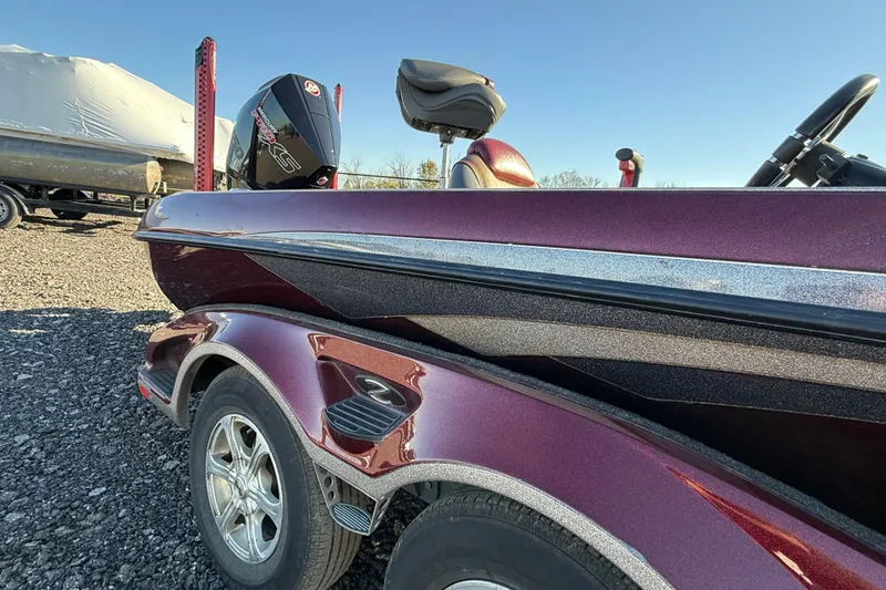 Slide: The Image of 2015 Ranger Z521C Ranger Cup Equipped boat, maroon color, parked on gravel. - 9