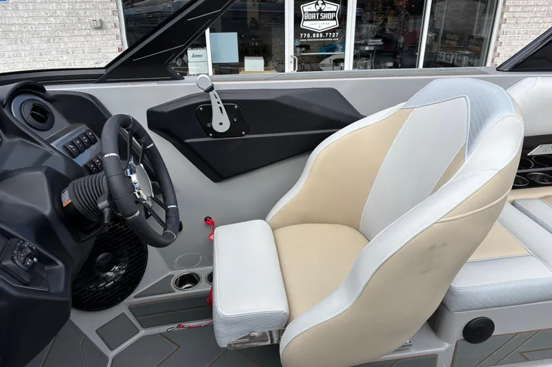Slide: The Image of Interior of 2026 Supreme S220 boat, featuring a modern steering wheel and comfortable seating. - 10