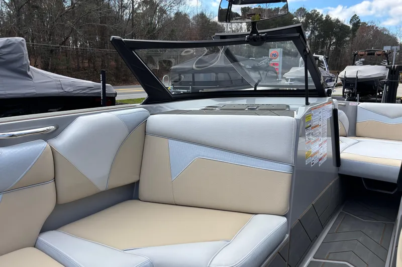 Slide: The Image of Interior of 2026 Supreme S220 boat with beige and gray seating, modern design. - 11