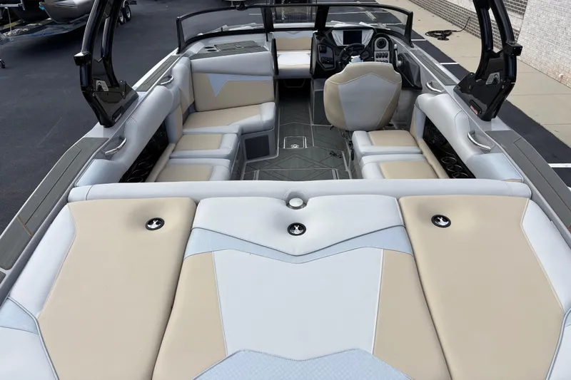 Slide: The Image of 2026 Supreme S220 boat interior with beige and gray seating, modern dashboard, and spacious layout. - 5