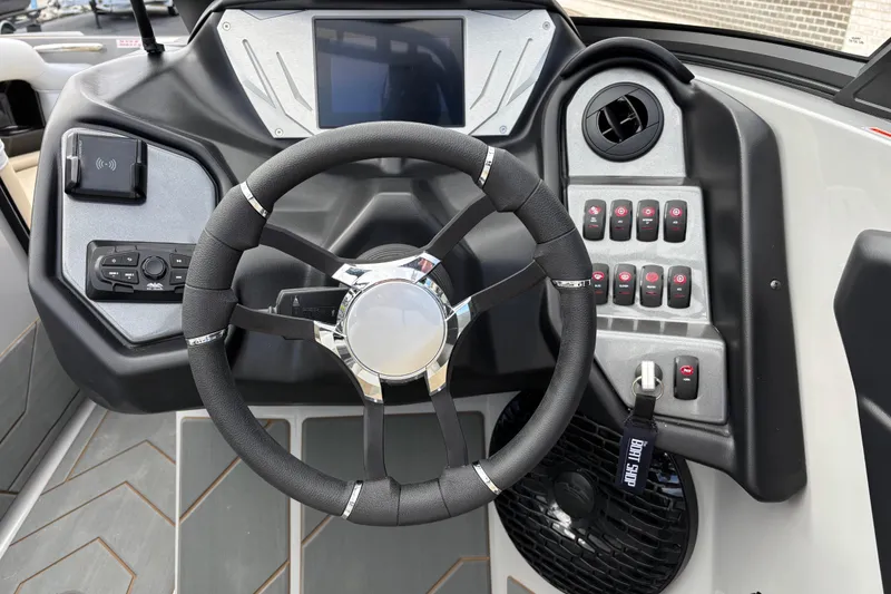 Slide: The Image of Steering wheel and dashboard of 2026 Supreme S220 boat with modern controls and display. - 9