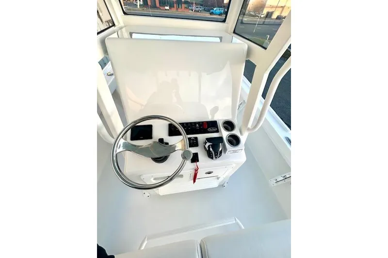 Slide: The Image of 2026 Pair Customs 24 Center Console MV boat helm with steering wheel and controls. - 14
