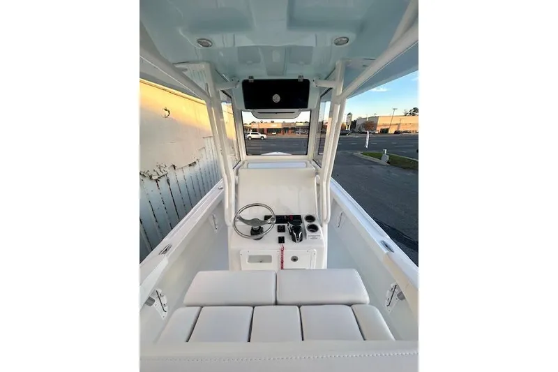 Slide: The Image of 2026 Pair Customs 24 Center Console MV boat interior with steering wheel and seating. - 16