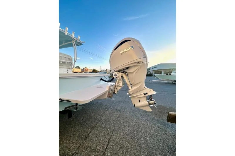 Slide: The Image of 2026 Pair Customs 24 Center Console MV with Yamaha outboard motor, docked under clear sky. - 19