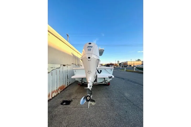 Slide: The Image of 2026 Pair Customs 24 Center Console MV with 300 V6 engine, parked outdoors. - 20