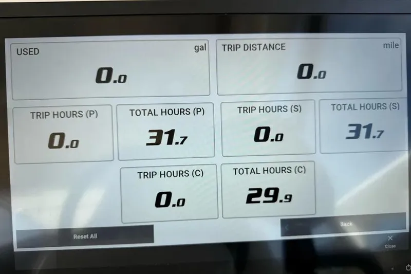 Slide: The Image of Display screen of 2023 Grady-White Freedom 335 showing trip and total hours data. - 12
