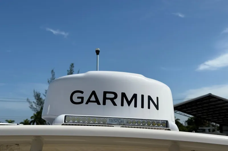 Slide: The Image of Garmin radar on 2023 Grady-White Freedom 335 boat under clear blue sky. - 18
