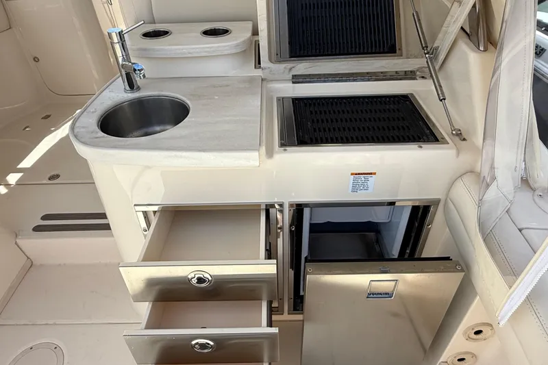 Slide: The Image of 2023 Grady-White Freedom 335 boat kitchen with sink, grill, and storage drawers. - 23