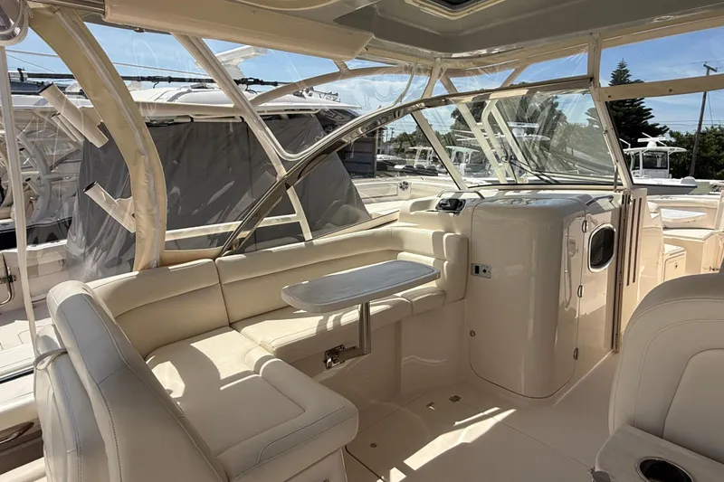 Slide: The Image of 2023 Grady-White Freedom 335 boat interior with seating and table, showcasing luxury design. - 25