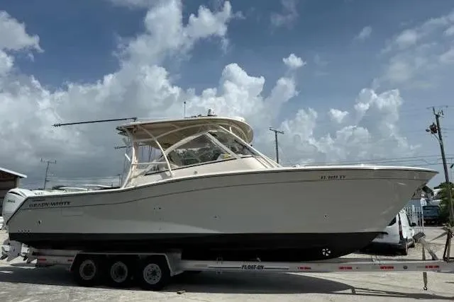 Slide: The Image of 2023 Grady-White Freedom 335 boat on trailer under cloudy sky. - 3