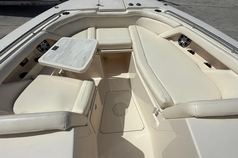 Slide: The Image of 2023 Grady-White Freedom 335 boat interior with cushioned seating and table. - 36