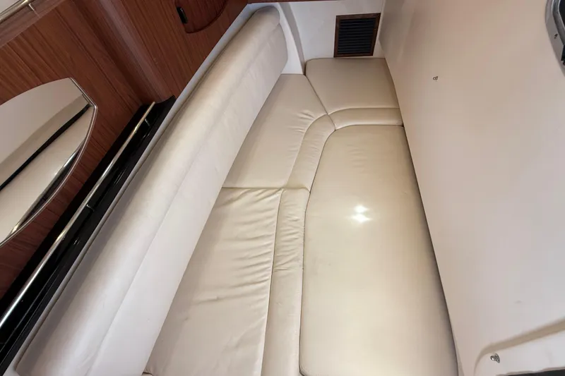 Slide: The Image of 2023 Grady-White Freedom 335 interior with cream leather seating and wood accents. - 37