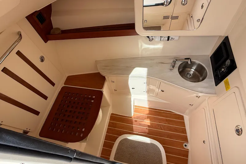 Slide: The Image of 2023 Grady-White Freedom 335 boat interior with sink and wooden flooring. - 39