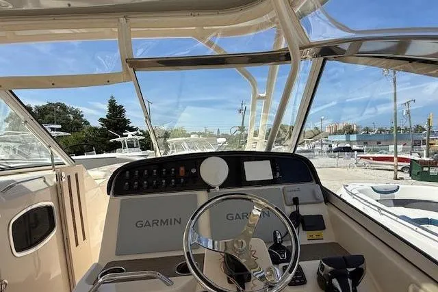 Slide: The Image of 2023 Grady-White Freedom 335 boat dashboard with Garmin navigation system. - 4