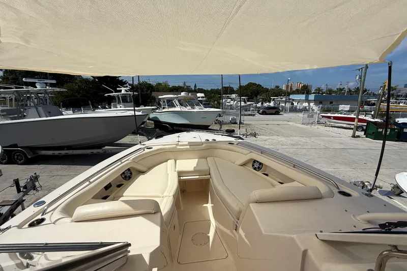 Slide: The Image of 2023 Grady-White Freedom 335 boat interior with seating, docked in a marina. - 40