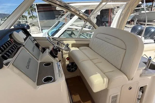 Slide: The Image of 2023 Grady-White Freedom 335 boat interior with helm, steering wheel, and seating. - 5
