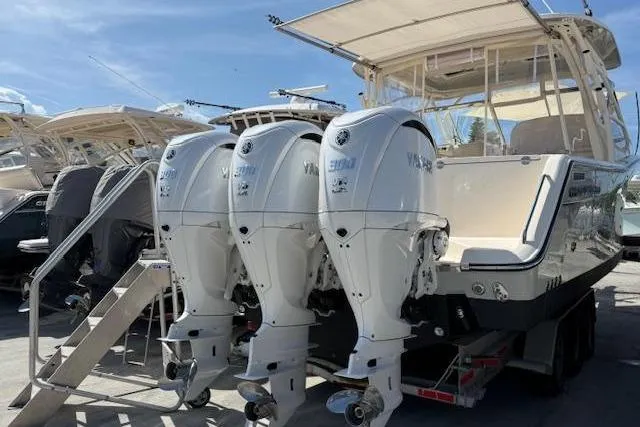Slide: The Image of 2023 Grady-White Freedom 335 boat with triple Yamaha outboard engines. - 7