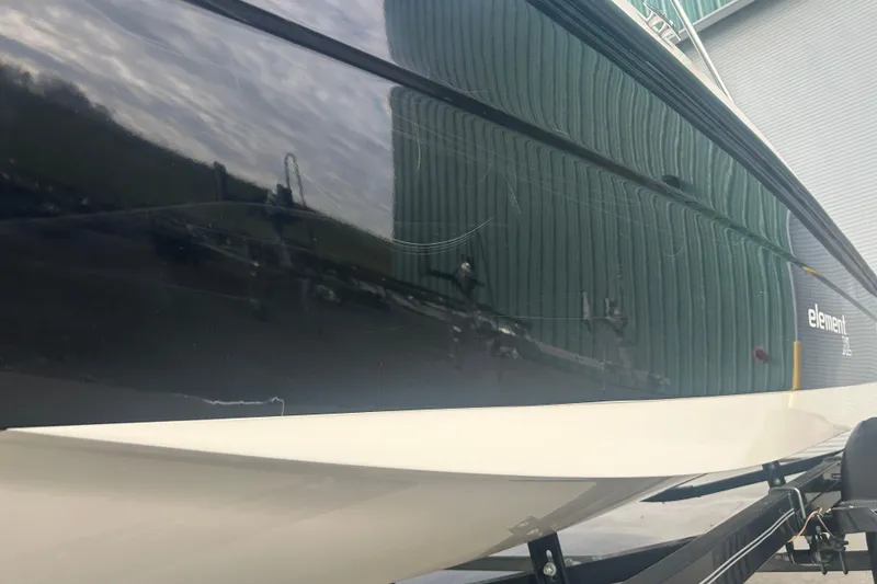Slide: The Image of 2016 Bayliner Element XL boat side view, reflecting surroundings, on a trailer. - 10