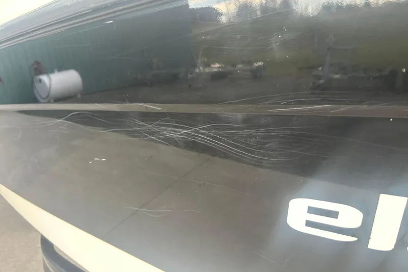 Slide: The Image of 2016 Bayliner Element XL boat with visible scratches on the hull. - 11