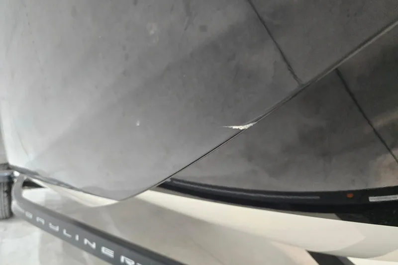 Slide: The Image of 2016 Bayliner Element XL boat hull with visible scratch on trailer. - 13