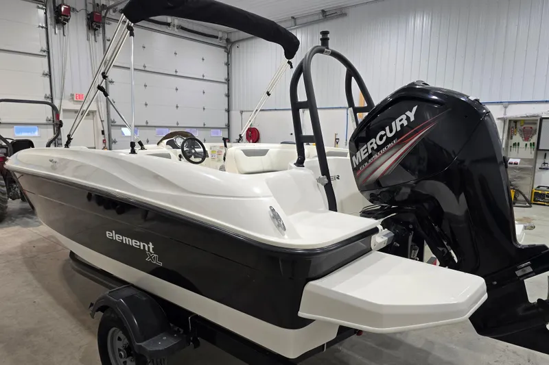 Slide: The Image of 2016 Bayliner Element XL boat with Mercury engine in a garage setting. - 18
