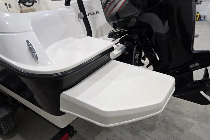 Slide: The Image of 2016 Bayliner Element XL boat with swim platform and outboard motor in a garage. - 19