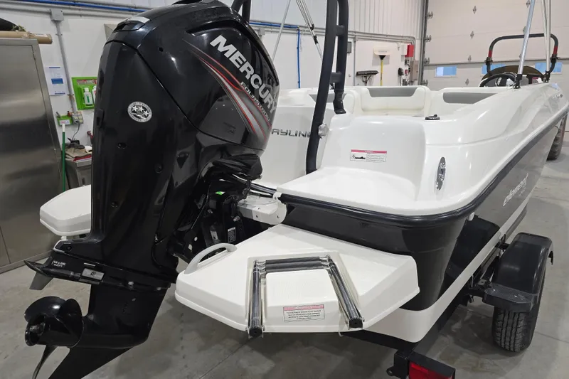 Slide: The Image of 2016 Bayliner Element XL boat with Mercury outboard motor in a garage setting. - 20