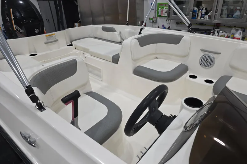 Slide: The Image of 2016 Bayliner Element XL boat interior with gray seating and steering wheel. - 27